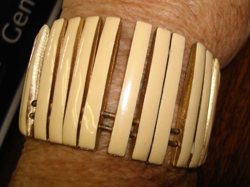 Vintage 1960s enamel cuff bracelet with silver-tone metal and creme enamel.