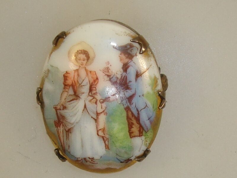 Victorian sterling silver and gold wash porcelain pin with a romantic couple scene