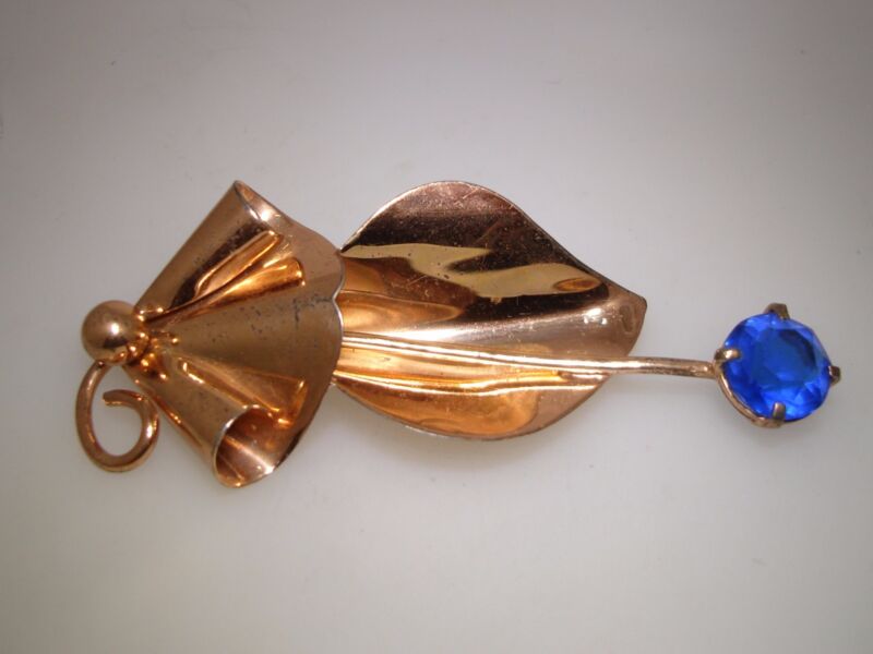 Vintage 1940s sterling silver rose gold brooch pin with a blue rhinestone leaf design.