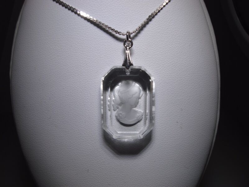 Sterling silver pendant necklace with reverse-carved glass design featuring a woman with roses