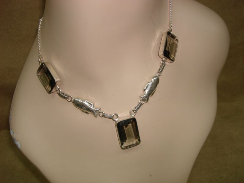 Sterling silver fish necklace with green glass stones