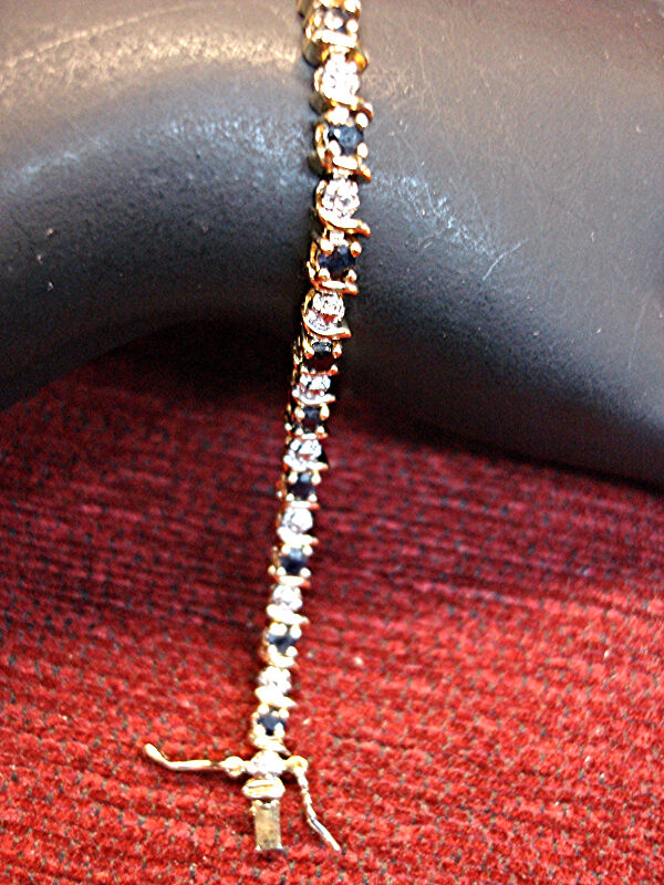 Sterling silver bracelet with gold vermeil finish and blue topaz gemstones.