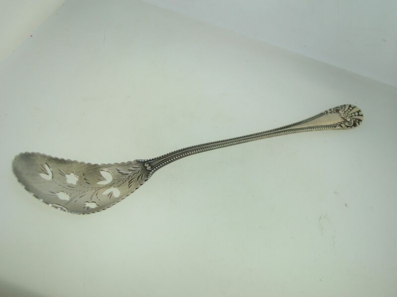 Antique Baker-Manchester sterling silver pierced olive spoon with floral design and gold wash