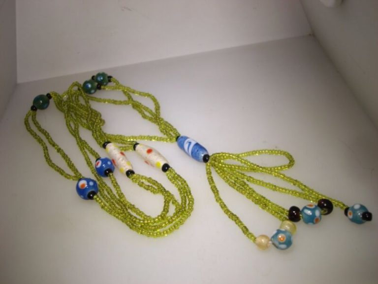 Vintage Art Deco necklace with lime green bugle beads, art glass beads, and a blue pendant.