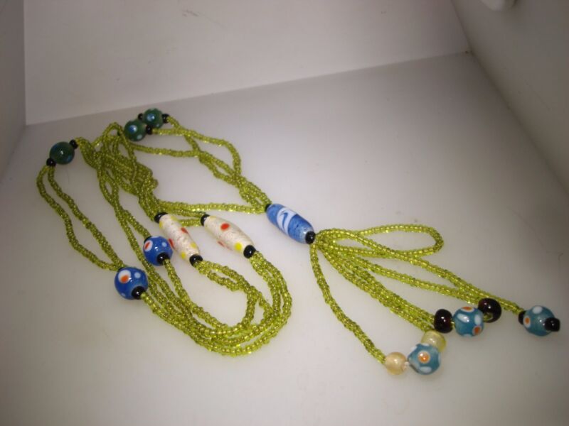 Vintage Art Deco necklace with lime green bugle beads, art glass beads, and a blue pendant.