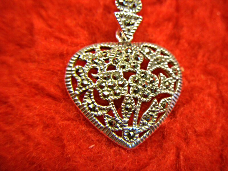 Vintage-inspired sterling silver heart pendant with marcasite floral design
