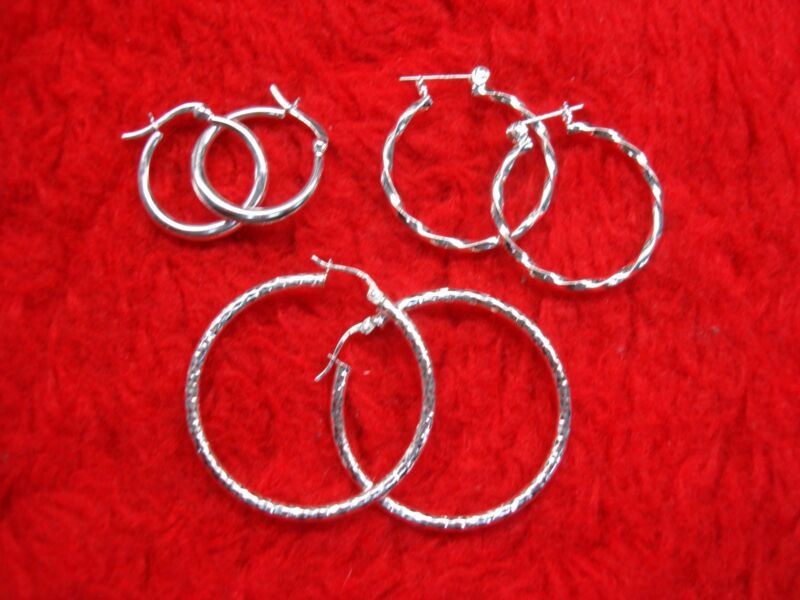 Set of three pairs sterling silver hoop earrings in plain, fancy and bold styles