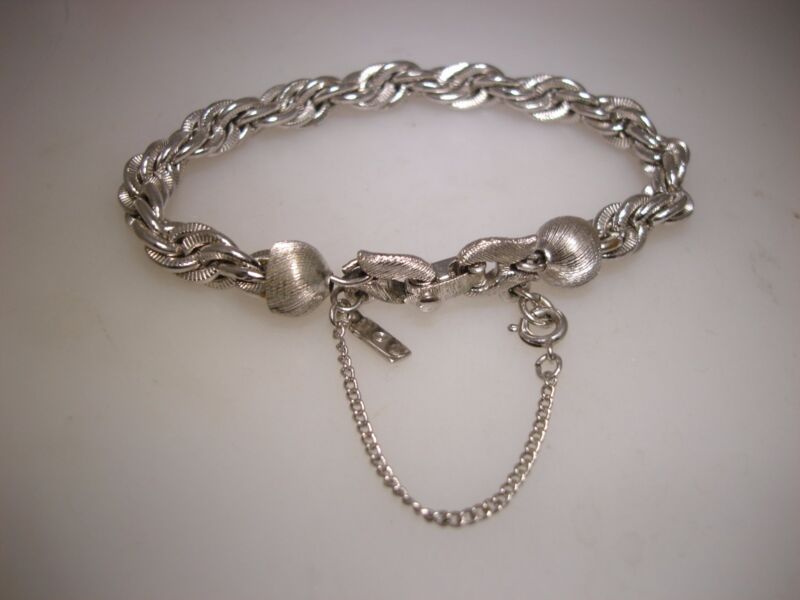Vintage 1970s Monet braided silver bracelet, triple ring design with safety chain