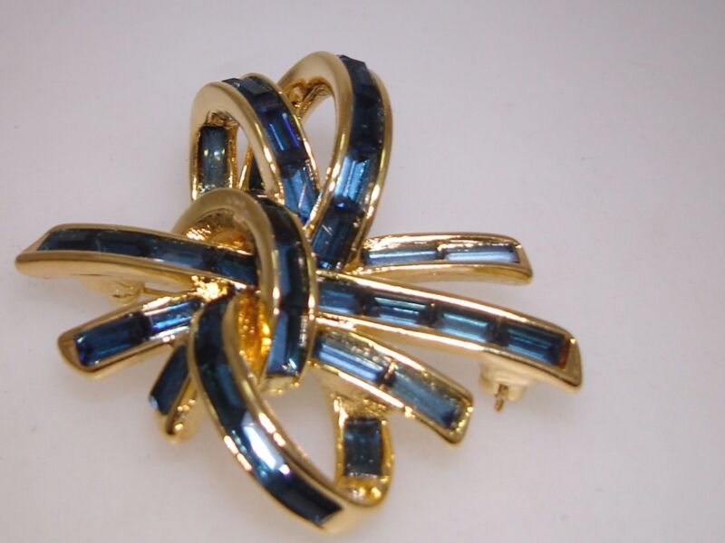 Vintage gold-tone bow pin with blue baguette rhinestones