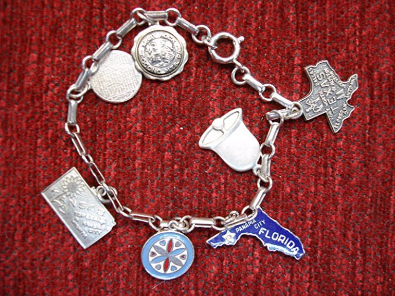 Vintage sterling silver charm bracelet with seven unique travel charms, including Texas A&M, Amish hex sign, and Split Rock.