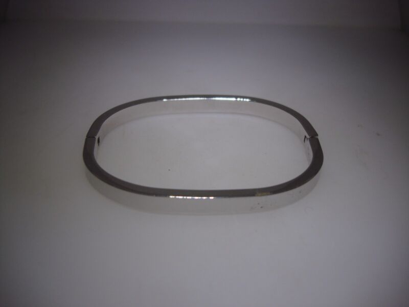 Vintage 1950s Crown Trifari silver bangle bracelet with an ultra-modern oval design
