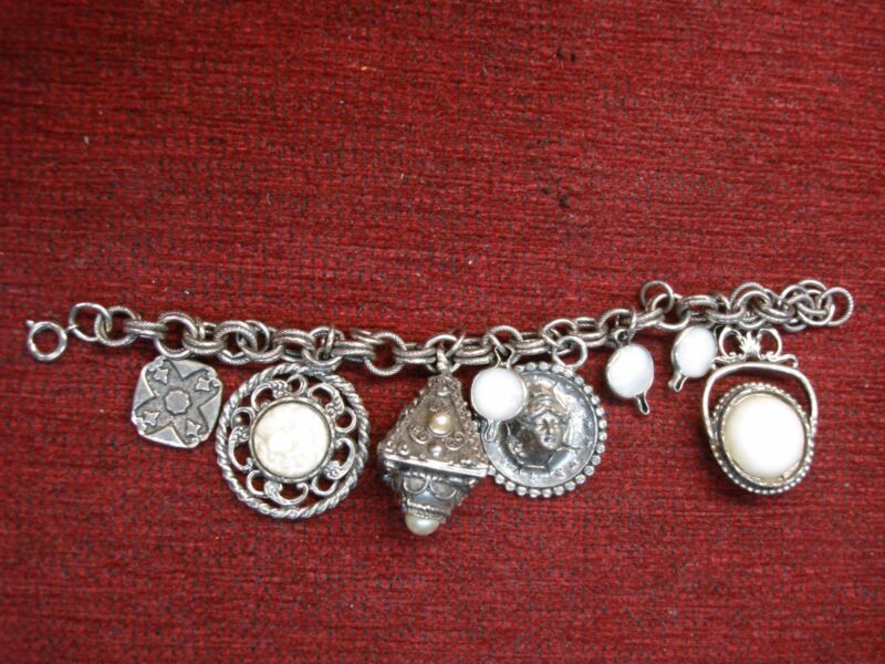 Vintage charm bracelet with unique, intriguing charms. Customizable with additional rings.