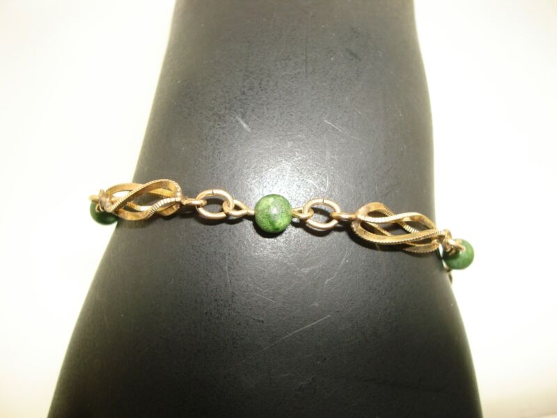 Vintage 1960s gold-filled jade bead bracelet with twisted cage design.
