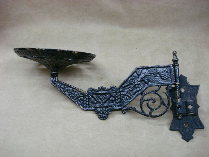 Antique Victorian cast iron swing arm lamp holder with ornate floral design, extends 13 inches