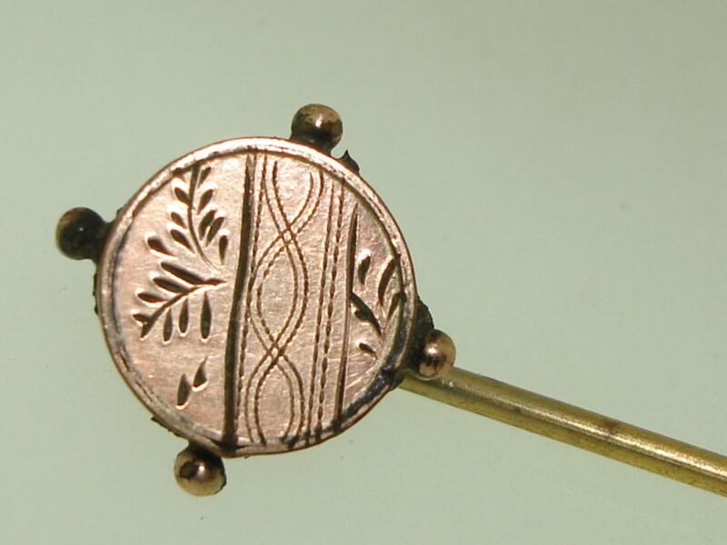Antique Edwardian rose gold stick pin with ornate leaf and swirl design