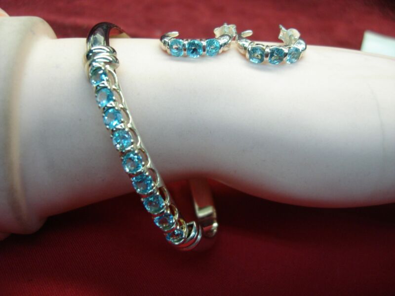 Sterling silver blue topaz clamper bracelet and earring set, signed C.I.