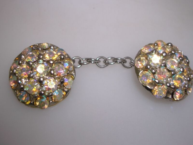 Vintage aurora borealis rhinestone buttons with a silver chain, perfect for sweater or vest accents.