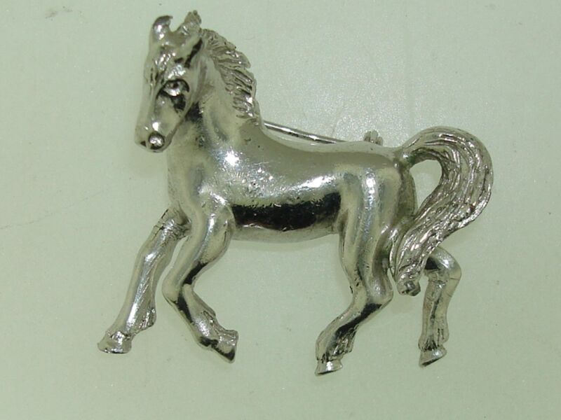 Vintage 1960s silver equestrian horse pin with detailed galloping design