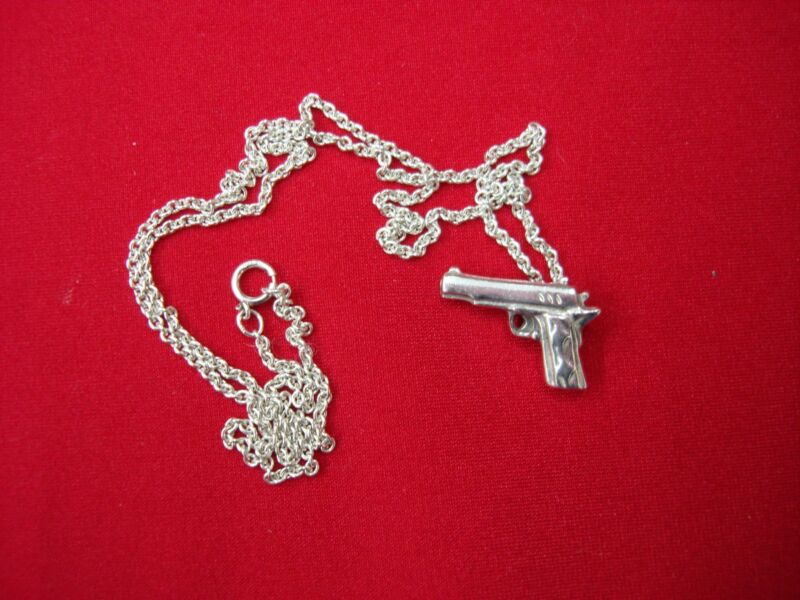 Sterling silver pistol pendant and chain, hallmarked 925
