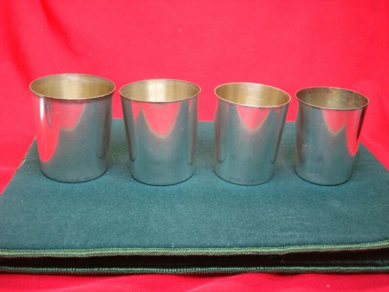Set of four vintage Meriden silver-plated nesting shot glasses with gold wash interior