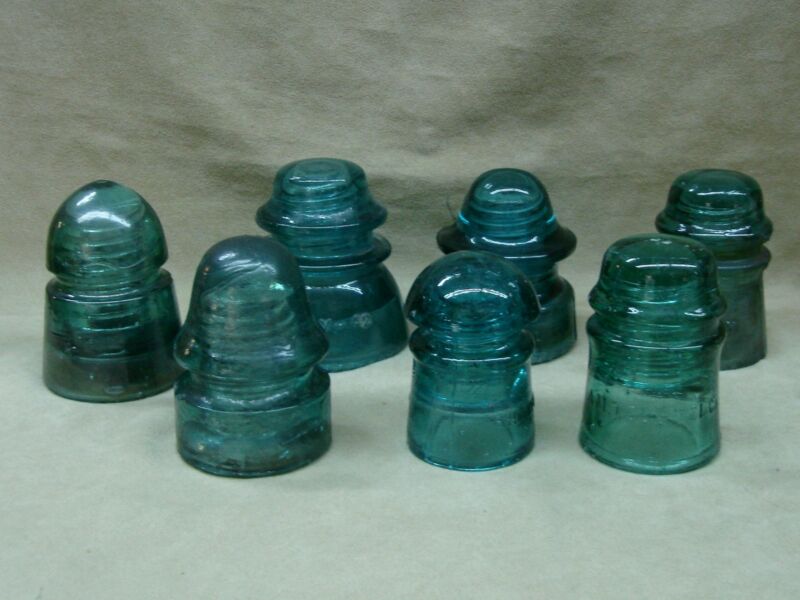 Vintage glass insulator collection featuring Hemingway, Brookfield, and AM TEL & TEL insulators.