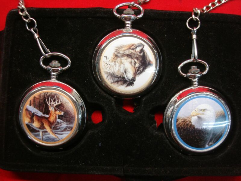 Vintage pocket watch trio featuring deer, wolf, and bald eagle designs. Estate find.