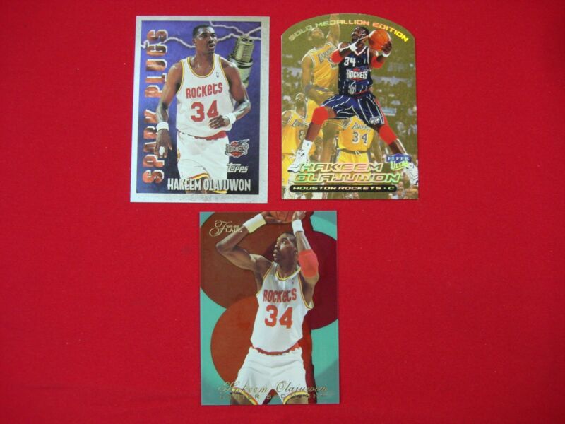 Hakeem Olajuwon rookie card lot featuring Gold Medallion, Spark Plugs, and Center Spotlight inserts.