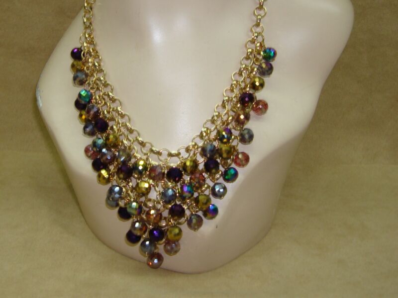 Gold-tone bib necklace with AB faceted beads in lavender, purple, and green