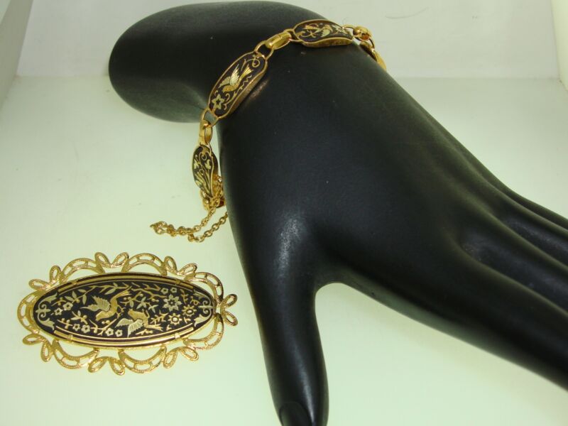 Vintage black and gold damascened bracelet and pin set with birds and flowers