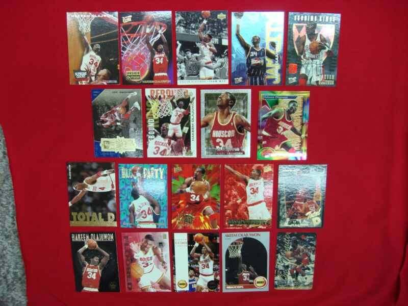 Hakeem Olajuwon basketball card lot featuring 19 premium Rockets cards with serial numbered inserts