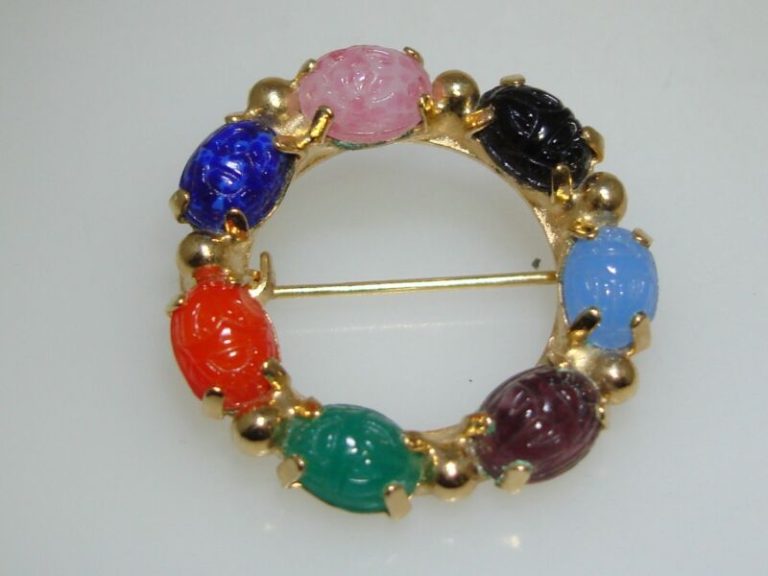 Vintage gold plated scarab beetle circle pin with seven genuine carved stones