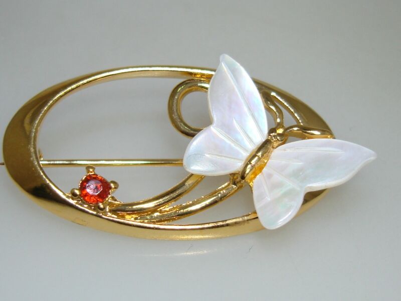 Gold tone mother of pearl butterfly brooch with rhinestone