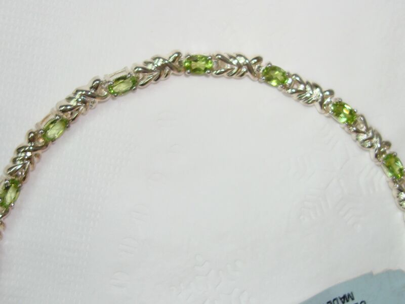 Stunning sterling silver peridot bracelet with a double twist design, new with tags