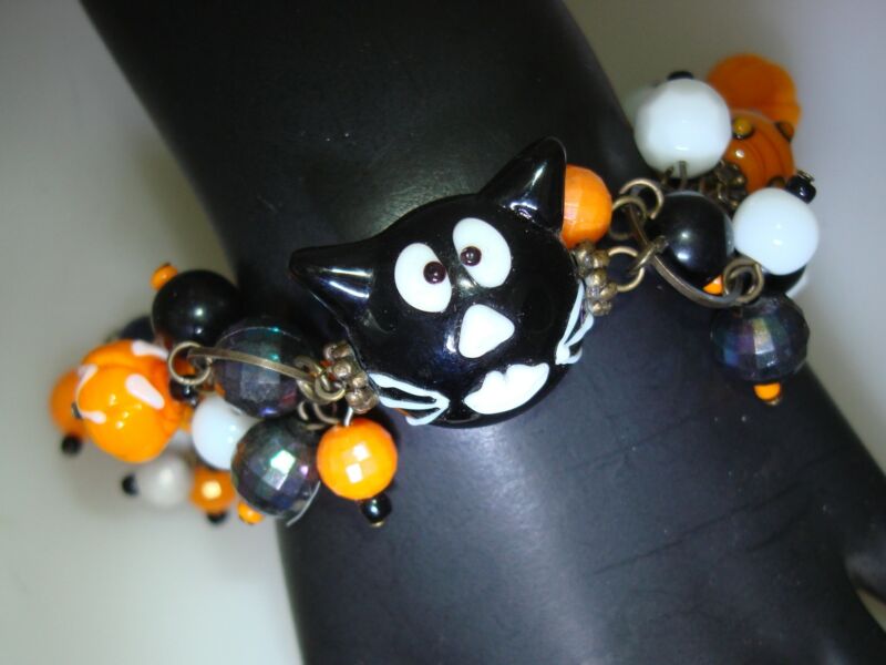 Handcrafted art glass Halloween bracelet with orange pumpkin and black cat charm