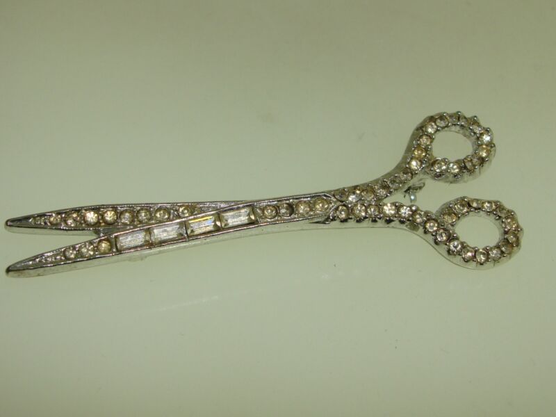 Vintage 1970s rhinestone scissor pin brooch in silver with baguette and round stones