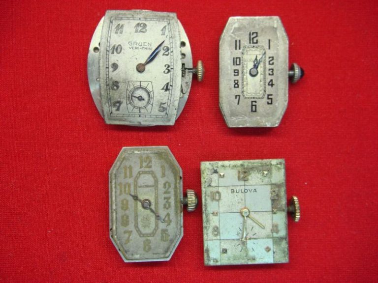 Collection of vintage gold-cased watch movements, perfect for restoration projects.