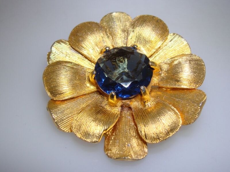 Vintage gold-tone flower brooch with blue rhinestone