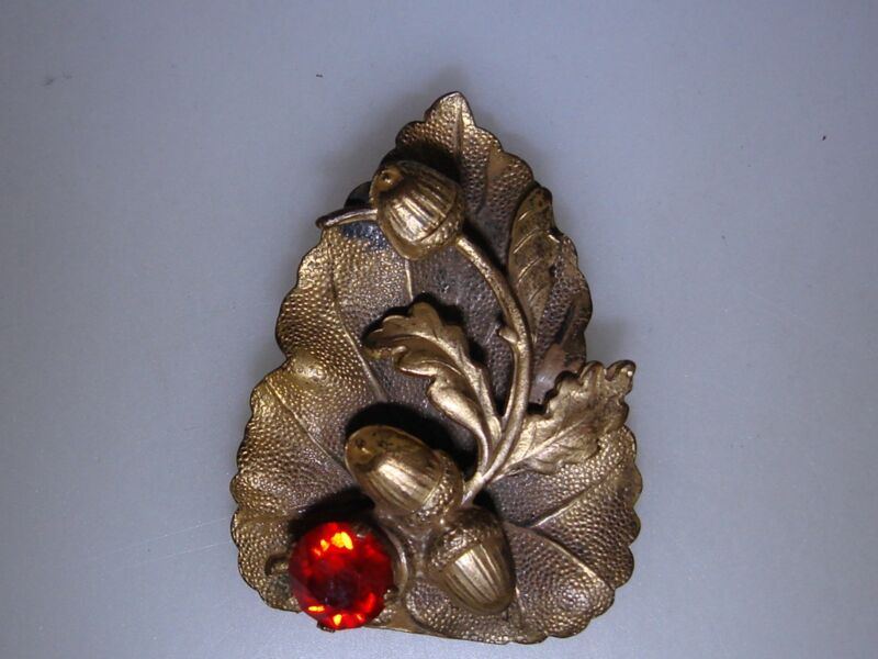 Vintage gold-plated oak leaf fur clip with acorns and a red rhinestone
