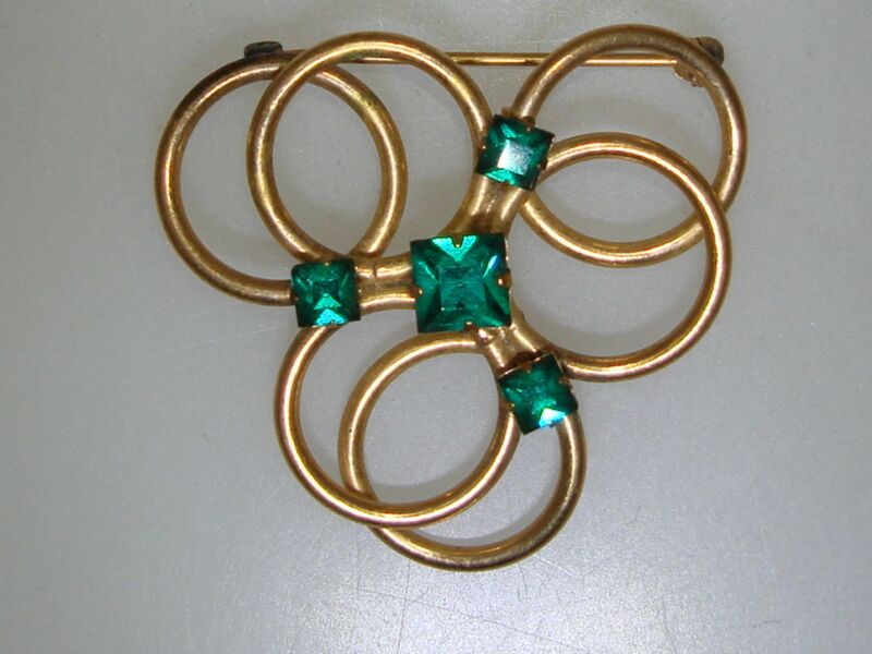 Vintage gold tone rhinestone pin with emerald green circles