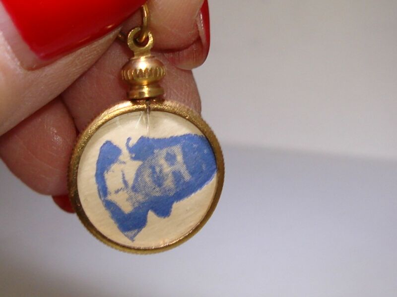 Vintage gold-tone celluloid photo holder charm from the 1940s-50s