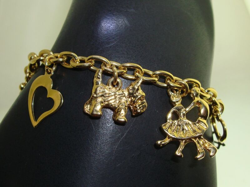Vintage 1980s Trifari gold tone charm bracelet with 13 charms, excellent condition