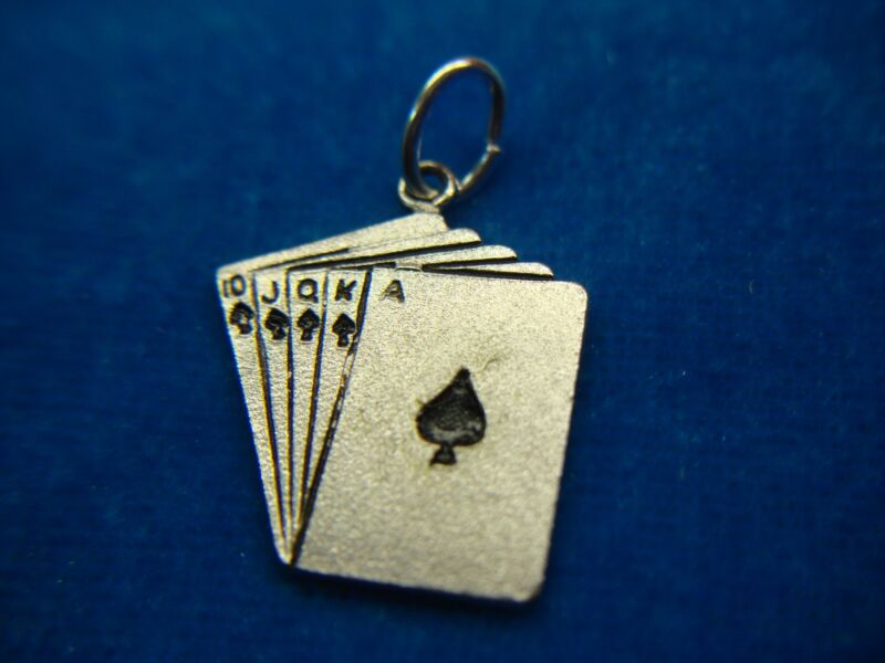 Sterling silver charm or pendant featuring a royal flush in spades with black enamel detailing