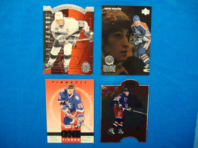 Collection of four rare Wayne Gretzky hockey cards from 1993-1999