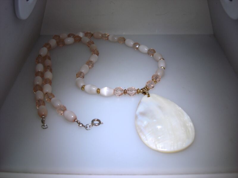Vintage iridescent mother of pearl necklace pendant with beaded details and a pear-shaped pendant