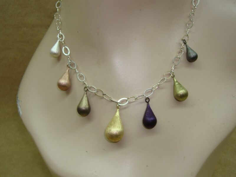 JCM Sterling Silver Graduated Teardrop Necklace in gold, silver, and purple tones