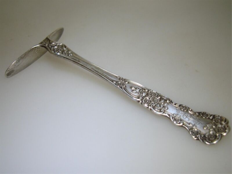 Antique sterling silver buttercup pattern baby food pusher by Bailey, Banks & Biddle