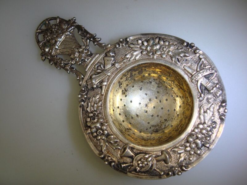 Antique Art Nouveau coin silver and gold washed tea strainer with floral design