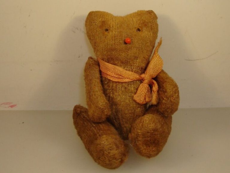 Antique mohair teddy bear with glass eyes and scarf