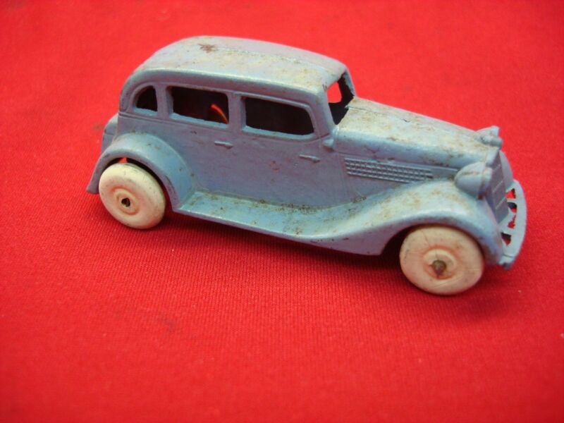 Vintage blue TootsieToy 1935 Ford Sedan toy car, showing signs of wear and tear. Parts or restoration project.