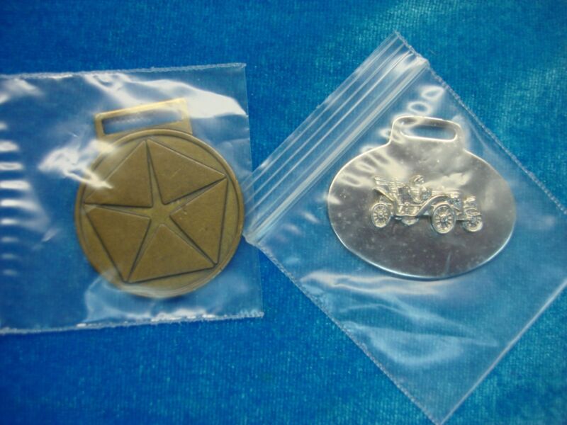Pair of vintage automobile fobs featuring a silver-tone car design and the Mopar logo